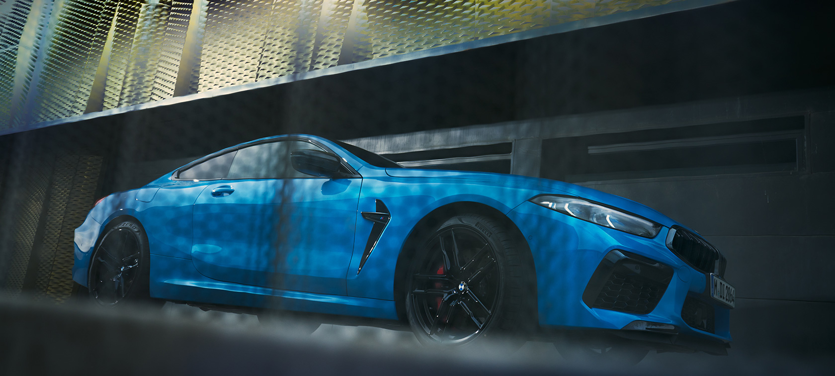 The BMW M8 Competition Coupé F92 LCI Facelift 2022 BMW Individual Daytona Beach Blue uni side view standing in front of a building low-angle shot