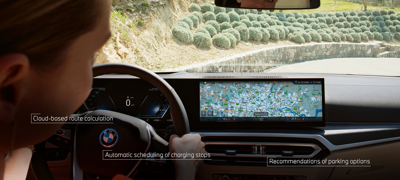 Man at the wheel of his BMW follows navigation instructions from BMW Maps in the Control Display